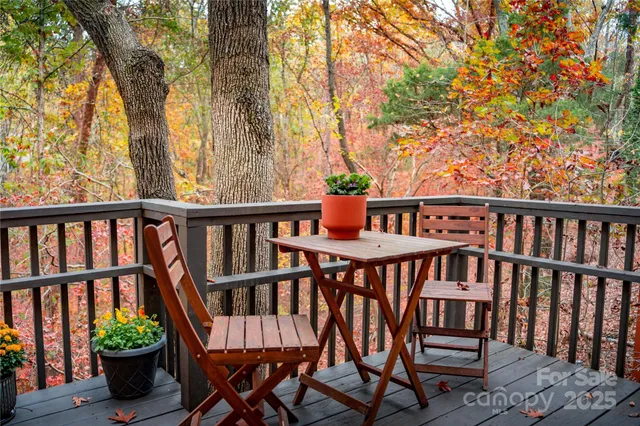 a view of a wooden chairs and bench on the deck