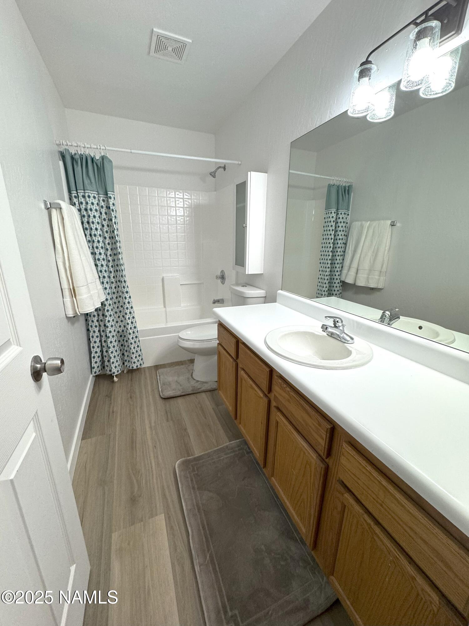 1807 North Main Street Flagstaff, AZ 86004 - Photo 19 of 26 a spacious bathroom with a double vanity sink a mirror and a bathtub
