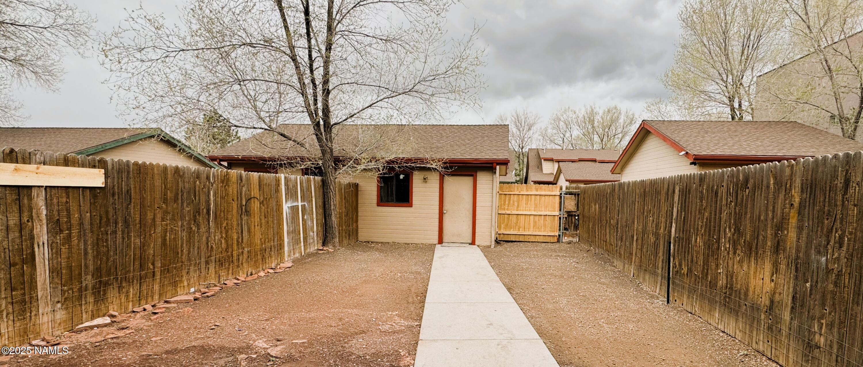 1807 North Main Street Flagstaff, AZ 86004 - Photo 25 of 26 a view of a house with a wooden fence
