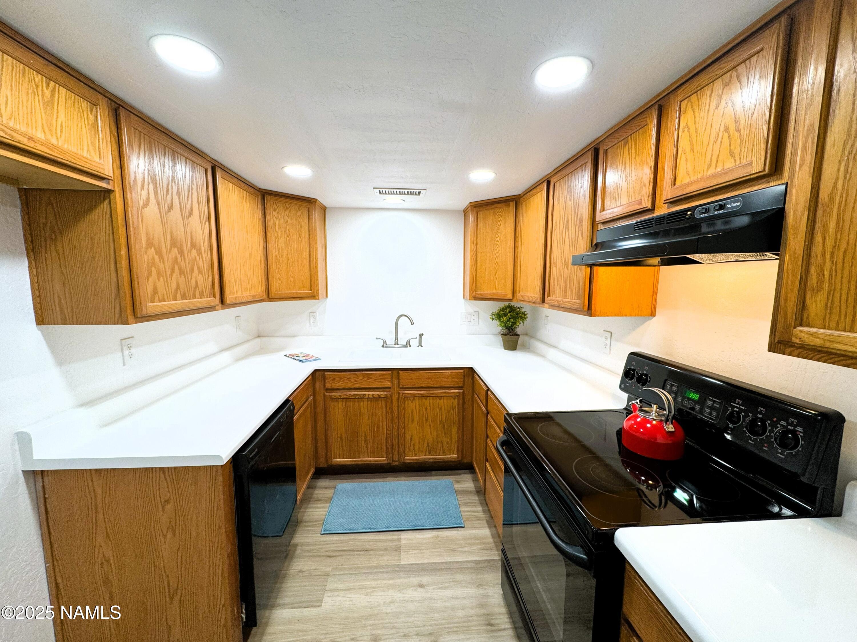 1807 North Main Street Flagstaff, AZ 86004 - Photo 9 of 26 a kitchen with stainless steel appliances a sink stove and cabinets