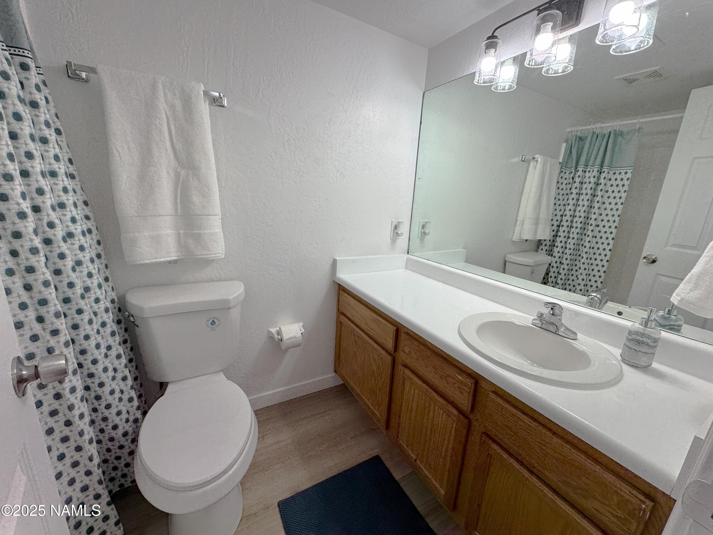 1807 North Main Street Flagstaff, AZ 86004 - Photo 10 of 26 a bathroom with a granite countertop toilet sink and mirror