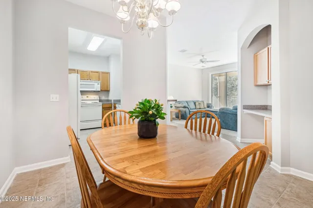 a dining room with furniture and chandelier