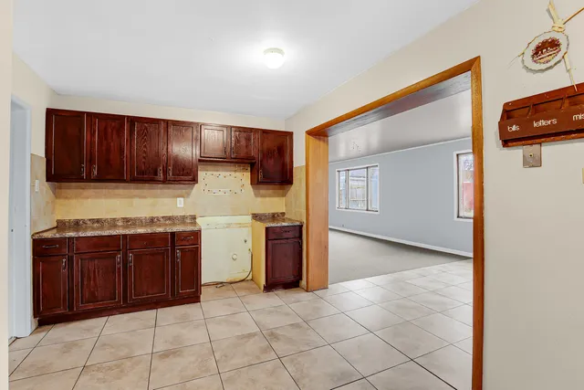 a kitchen with a stove top oven and cabinets