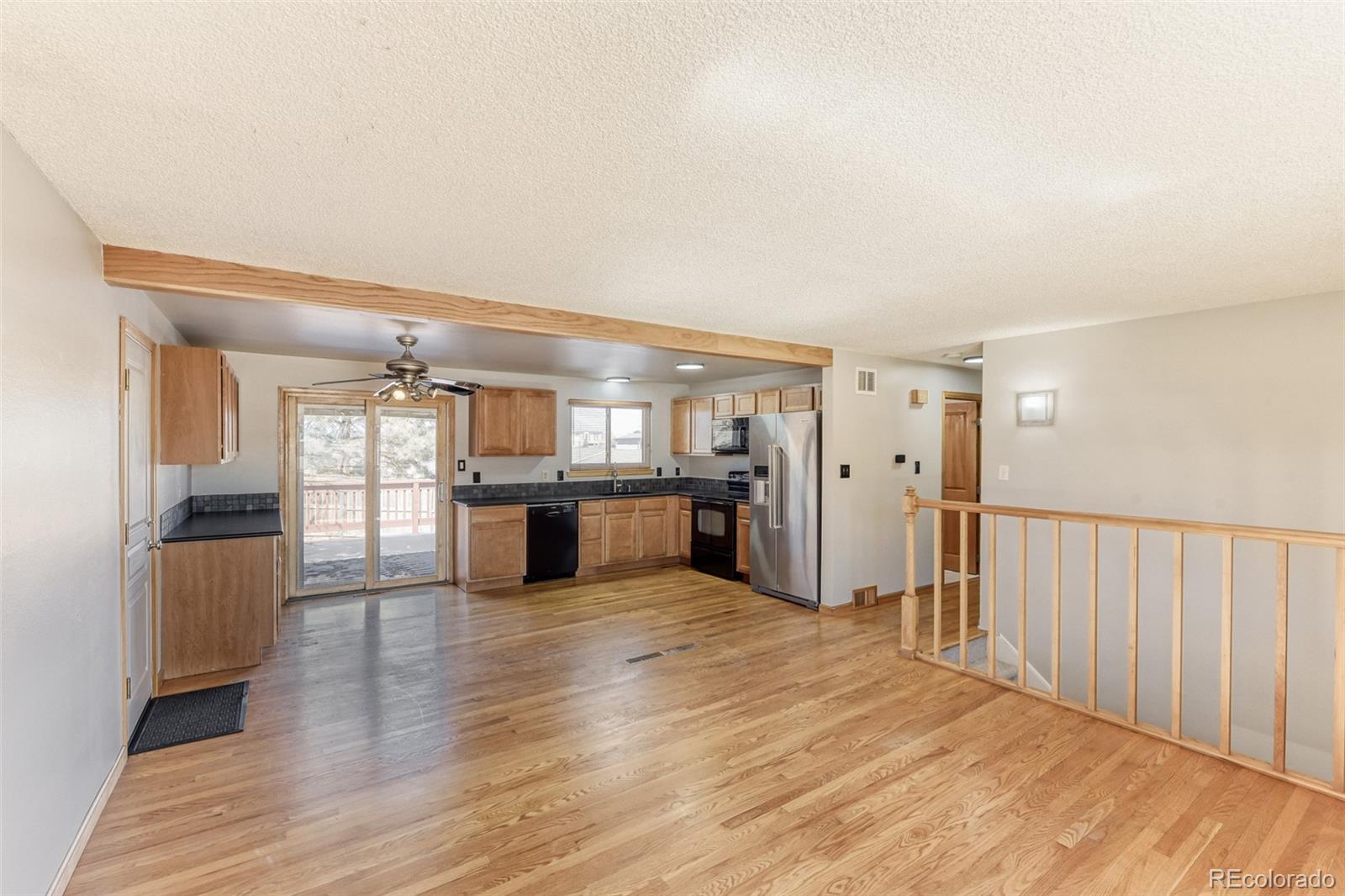 128 Olympus Circle Lone Tree, CO 80124 - Photo 15 of 35 a view of a living room with kitchen view and wooden floor