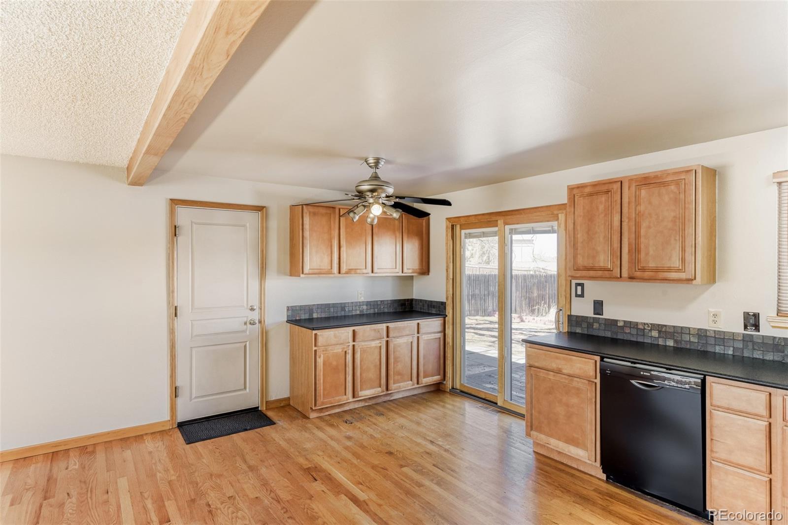 128 Olympus Circle Lone Tree, CO 80124 - Photo 17 of 35 a kitchen with granite countertop a sink stainless steel appliances and cabinets