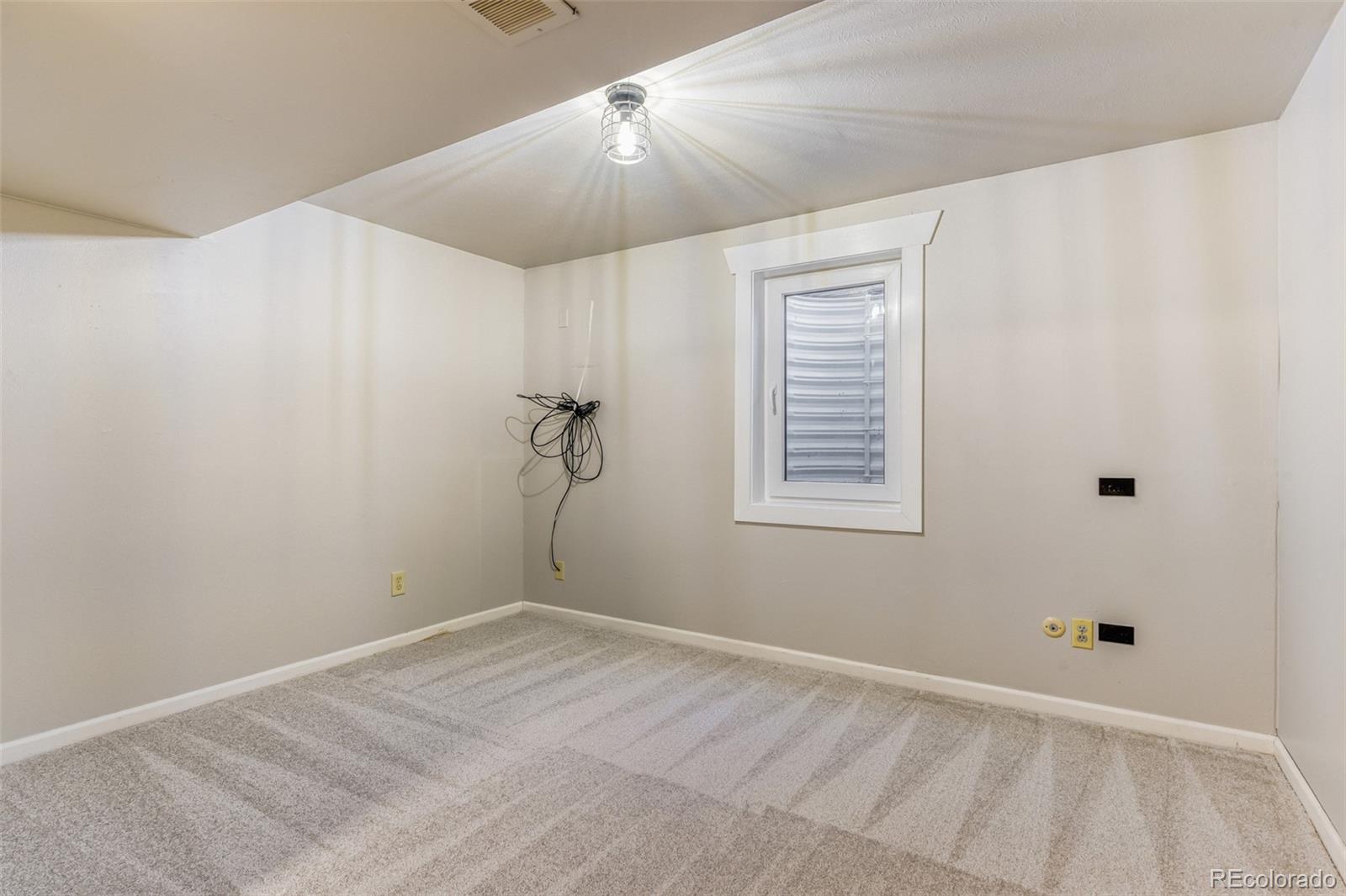 128 Olympus Circle Lone Tree, CO 80124 - Photo 19 of 35 a view of a room with rack on the wall and a window