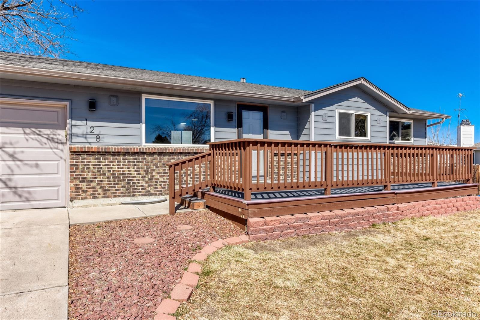 128 Olympus Circle Lone Tree, CO 80124 - Photo 32 of 35 a view of house with backyard and deck