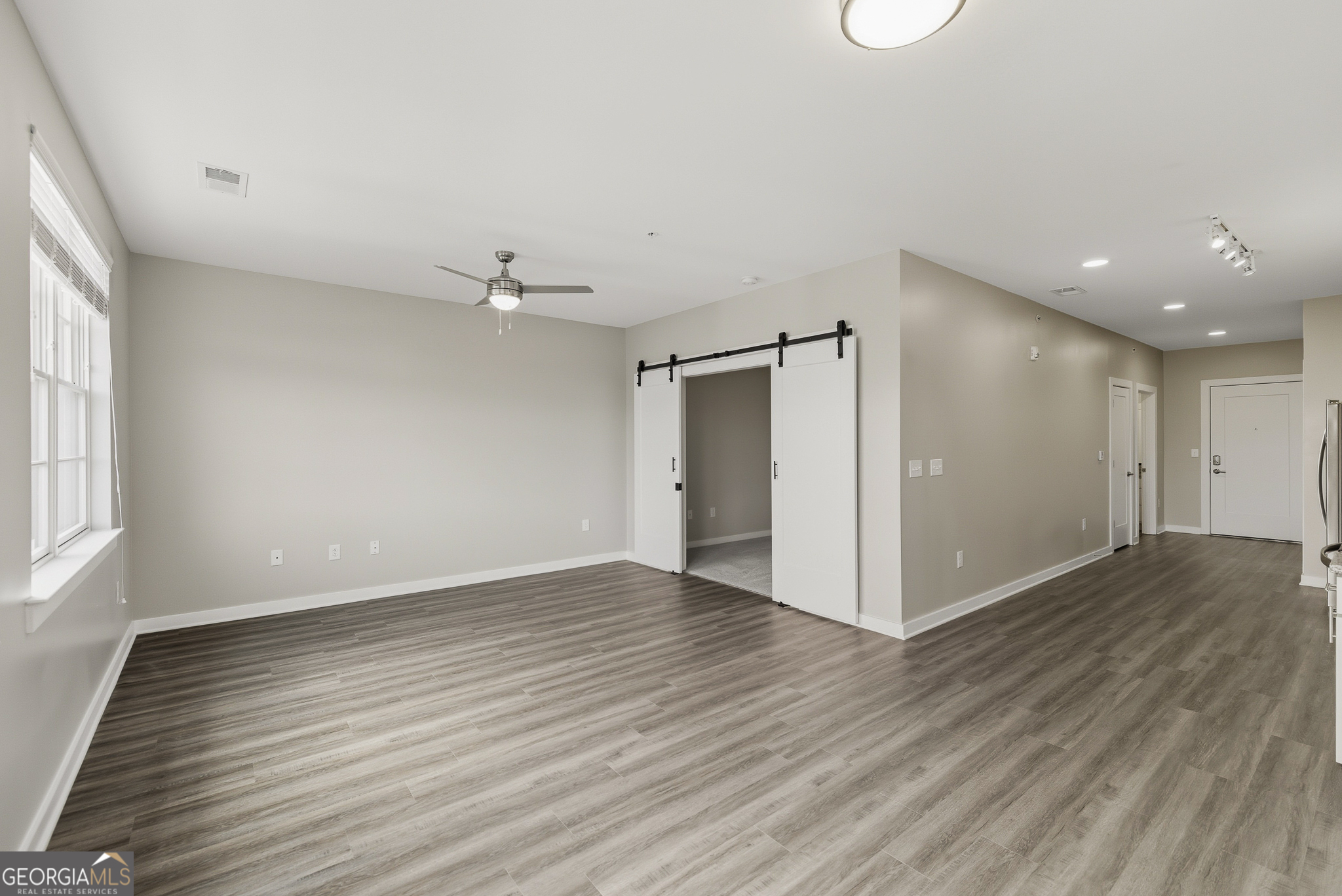 100 Prince Avenue, Unit A303 Athens, GA 30601 - Photo 15 of 27 an empty room with wooden floor and windows