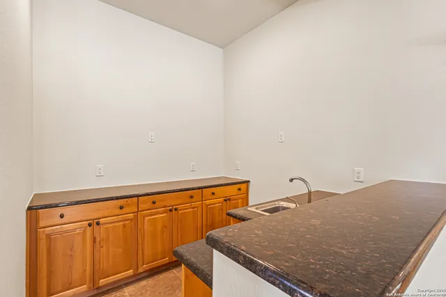 a kitchen with a sink a counter top space and a window