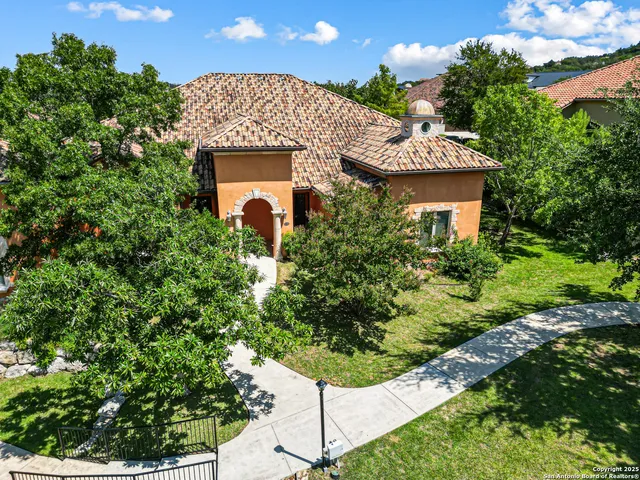 an aerial view of a house with a yard
