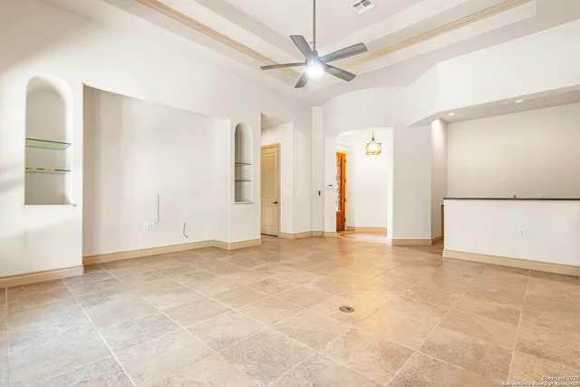 a view of an empty room with a ceiling fan