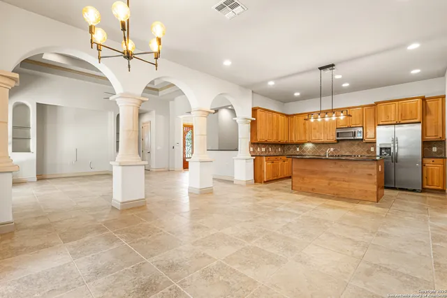a view of a kitchen with refrigerator and a stove