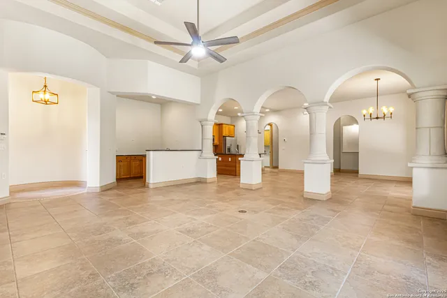 a view of a kitchen with a sink and chandelier