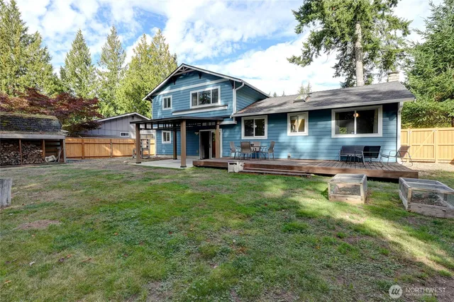 an aerial view of a house with swimming pool garden and patio