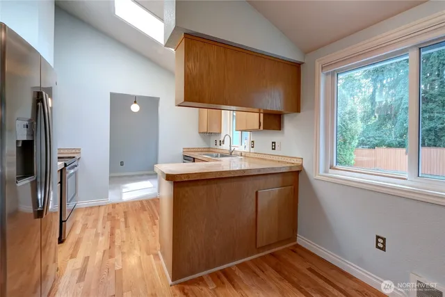 a kitchen with a sink stove and refrigerator