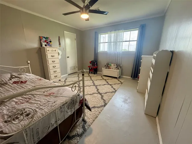 a bedroom with a bed dresser and a window