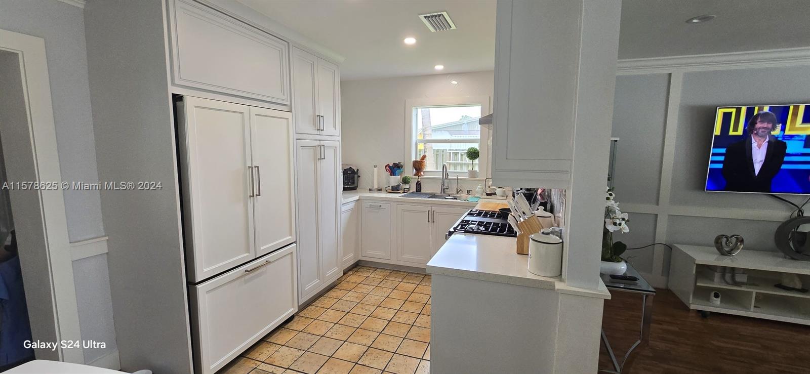 30018 Southwest 159th Drive Homestead, FL 33033 - Photo 13 of 27 a view of a kitchen with fridge and workspace