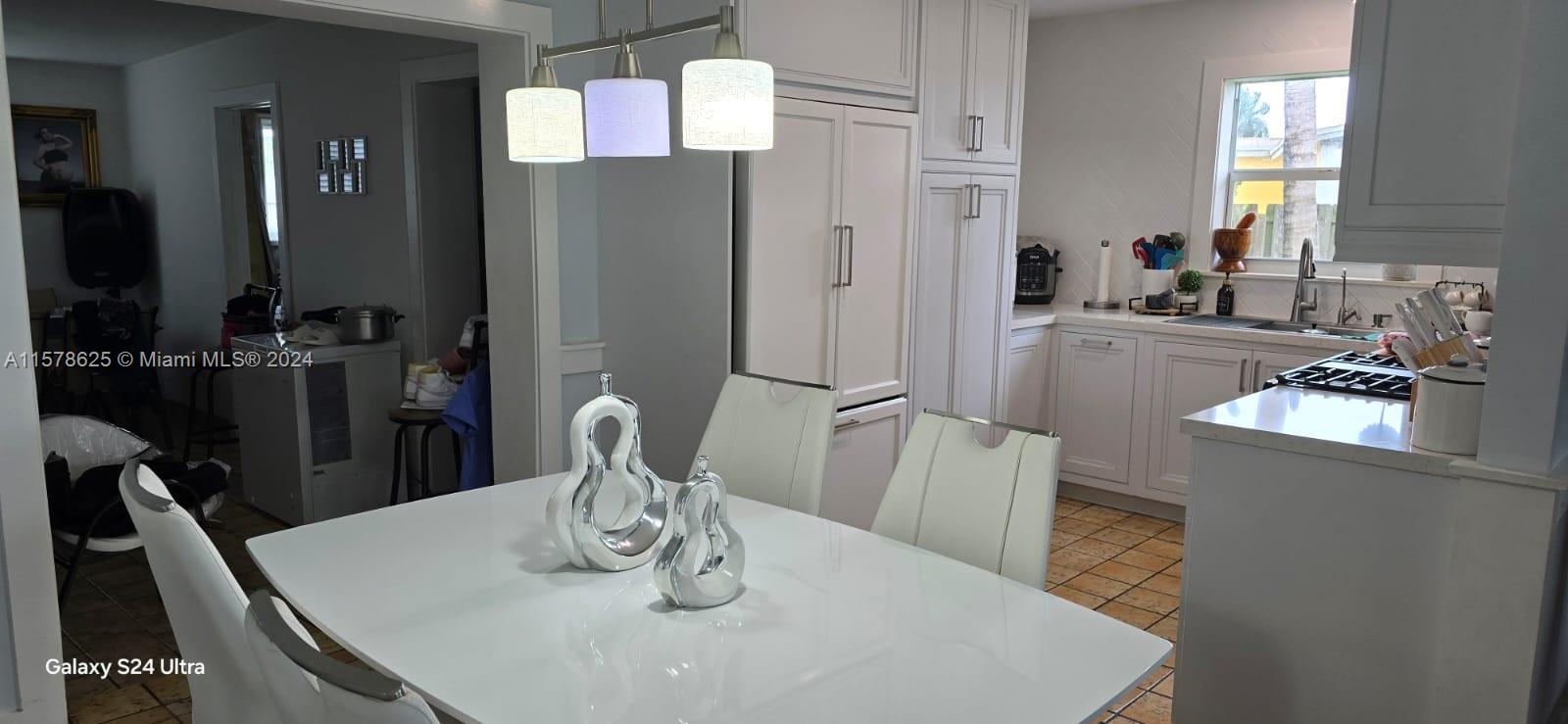 30018 Southwest 159th Drive Homestead, FL 33033 - Photo 14 of 27 a kitchen with a table and chairs in it