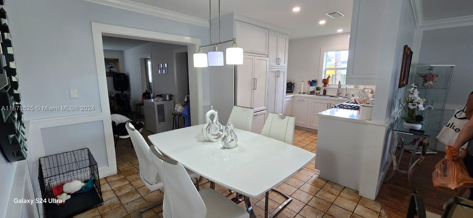 30018 Southwest 159th Drive Homestead, FL 33033 - Photo 15 of 27 a view of a dining room with furniture and a flat screen tv