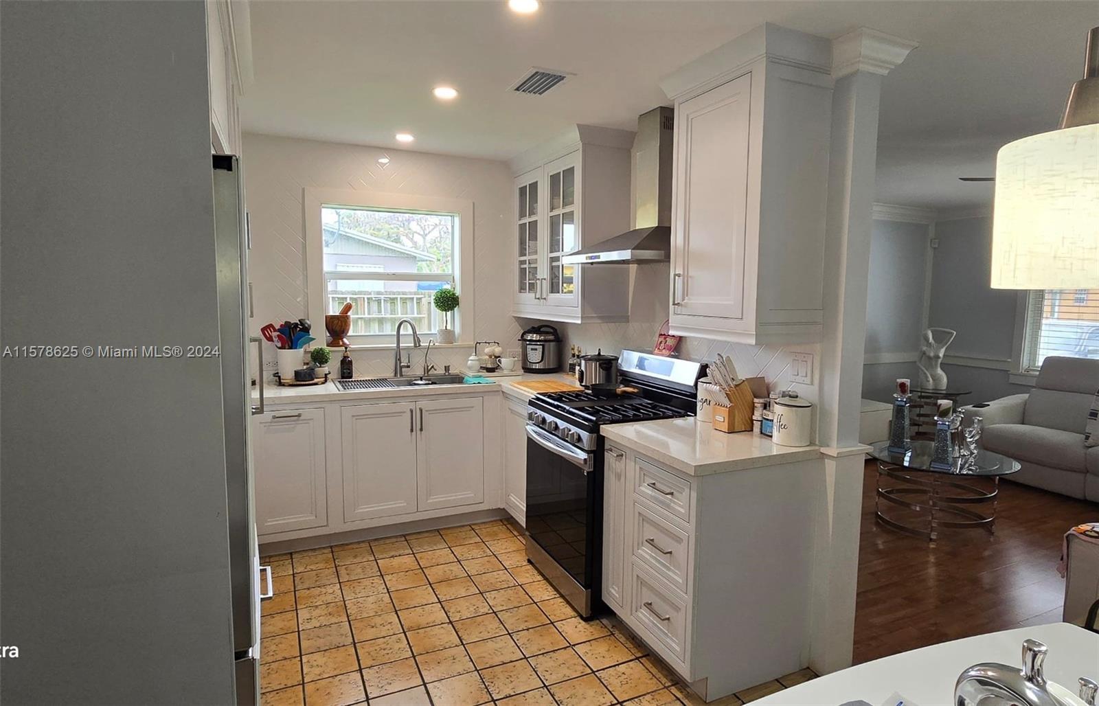 30018 Southwest 159th Drive Homestead, FL 33033 - Photo 16 of 27 a kitchen with a sink stove and cabinets