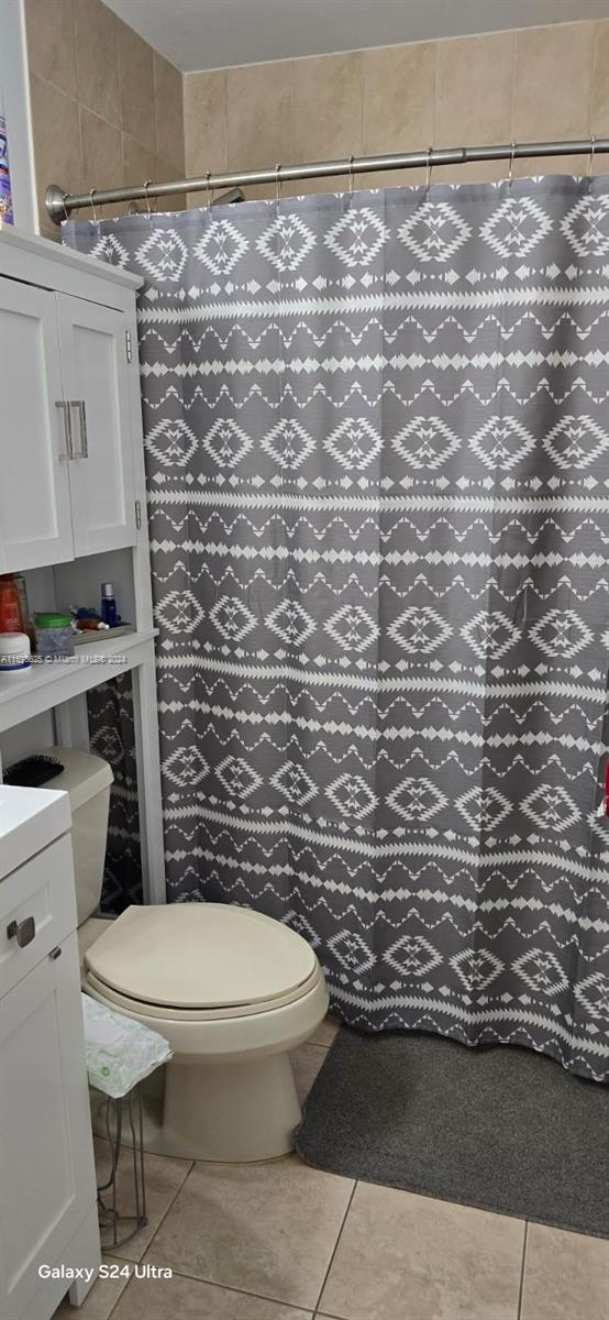 30018 Southwest 159th Drive Homestead, FL 33033 - Photo 20 of 27 a white toilet sitting next to a shower curtain