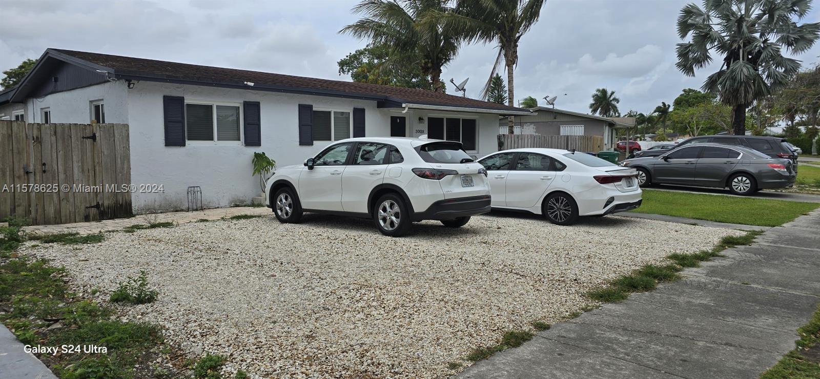 30018 Southwest 159th Drive Homestead, FL 33033 - Photo 3 of 27 a front view of a house with parking space
