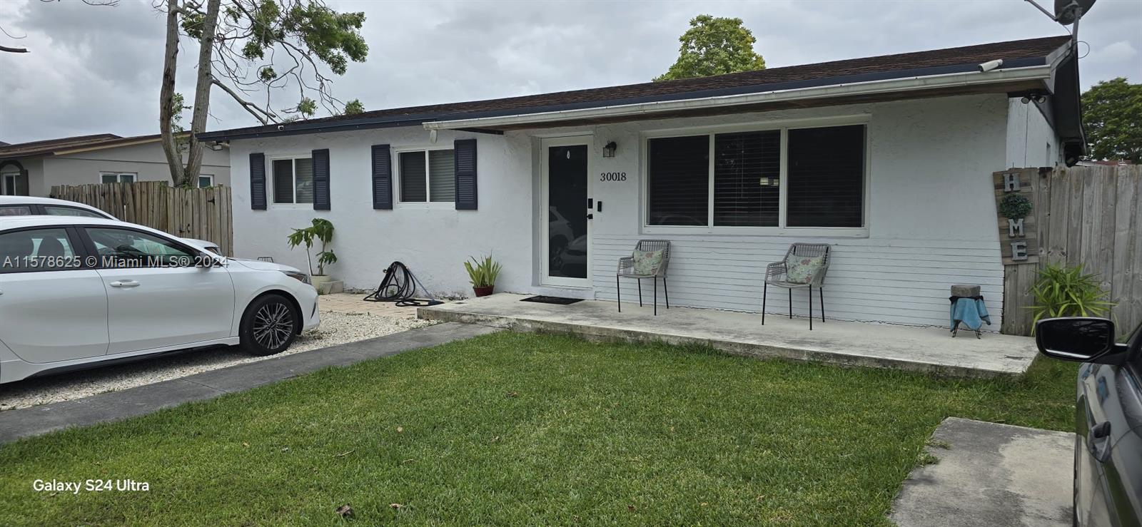 30018 Southwest 159th Drive Homestead, FL 33033 - Photo 4 of 27 a front view of a house with a garden