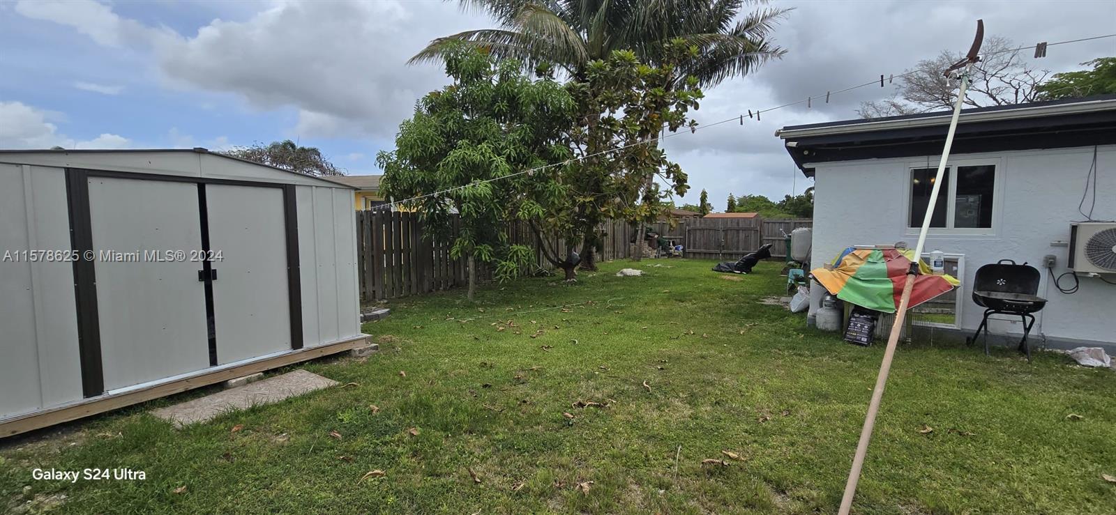 30018 Southwest 159th Drive Homestead, FL 33033 - Photo 7 of 27 a backyard of a house with table and chairs