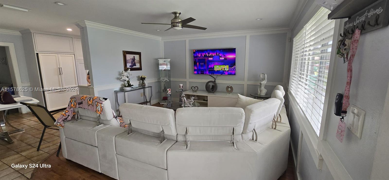 30018 Southwest 159th Drive Homestead, FL 33033 - Photo 9 of 27 a living room with furniture a flat screen tv and a fireplace