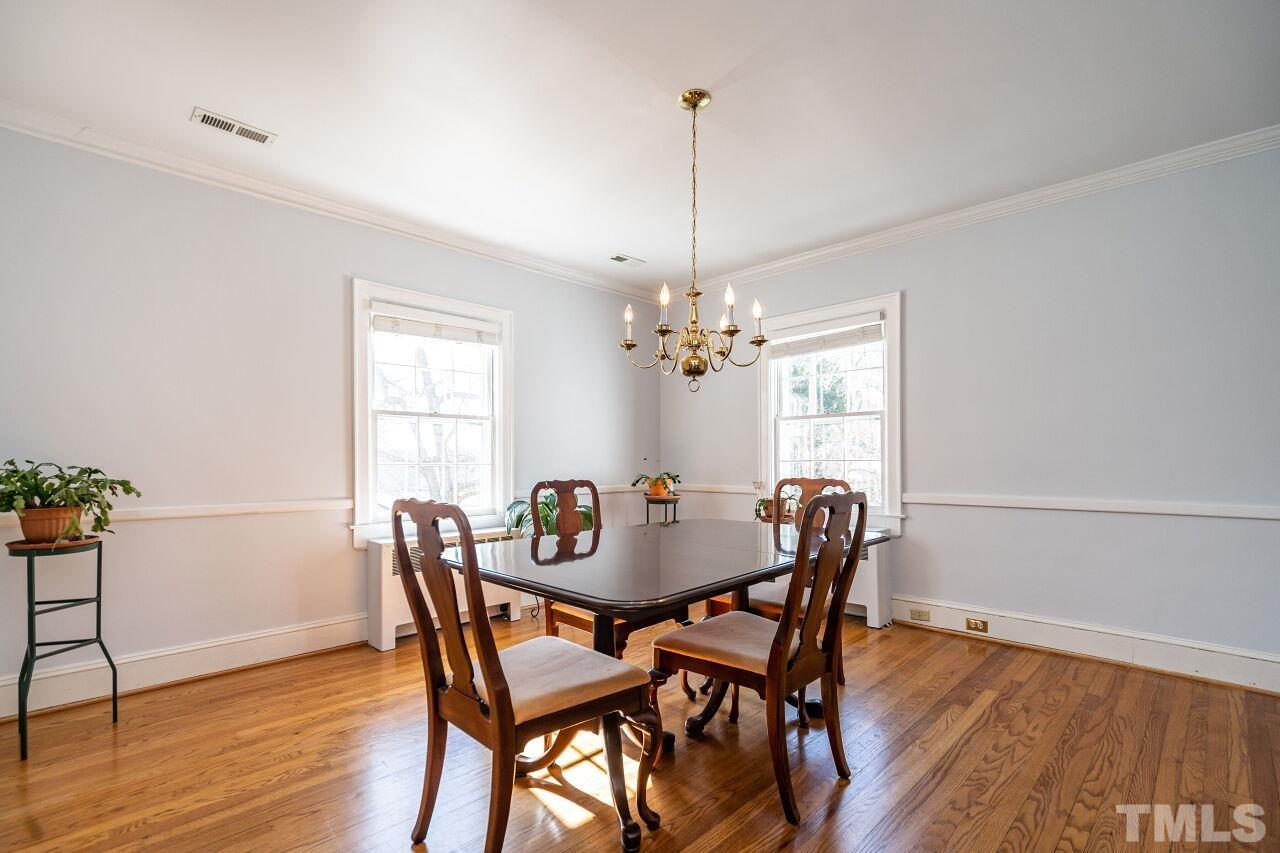 5212 Theys Road Raleigh, NC 27606 - Photo 16 of 55 a view of a dining room with furniture window and wooden floor