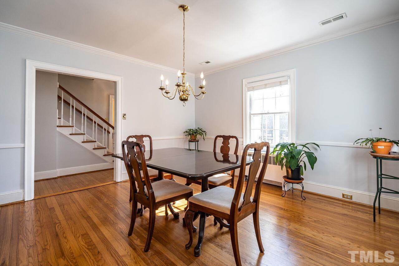 5212 Theys Road Raleigh, NC 27606 - Photo 17 of 55 a view of a dining room with furniture window and wooden floor