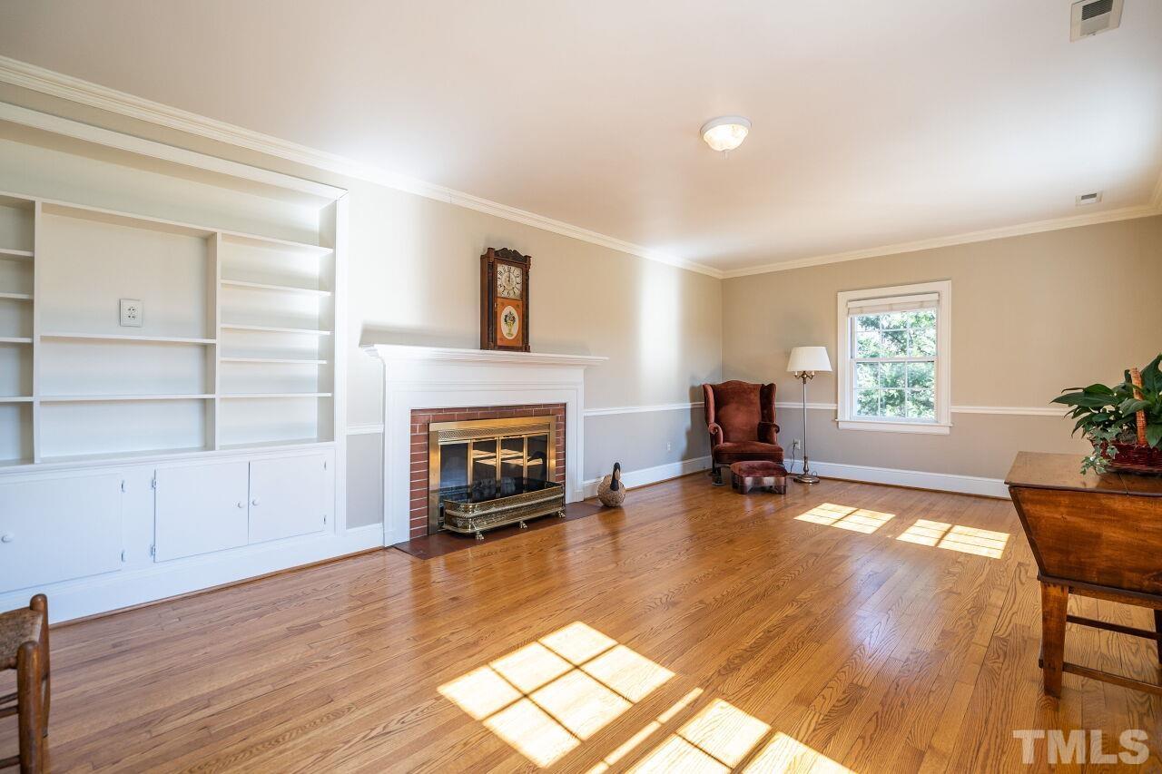 5212 Theys Road Raleigh, NC 27606 - Photo 18 of 55 a living room with furniture and a fireplace