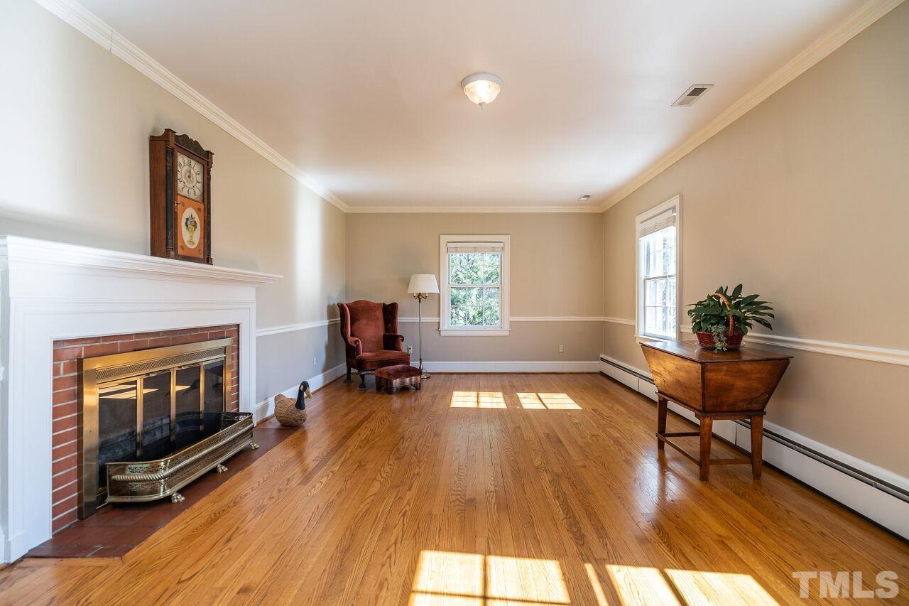 5212 Theys Road Raleigh, NC 27606 - Photo 19 of 55 a view of a livingroom with furniture and a fireplace