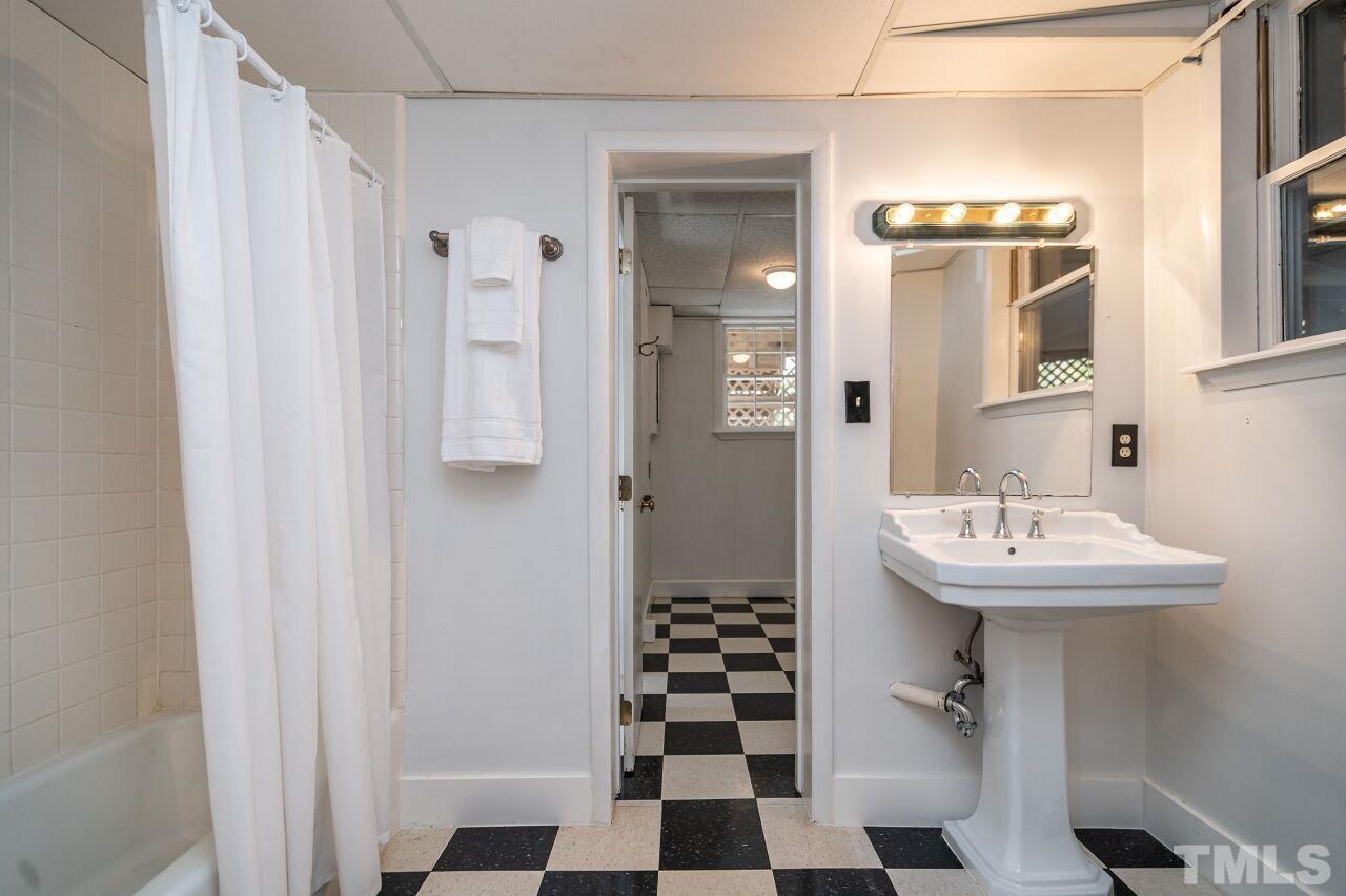 5212 Theys Road Raleigh, NC 27606 - Photo 39 of 55 a bathroom with a sink a toilet and shower