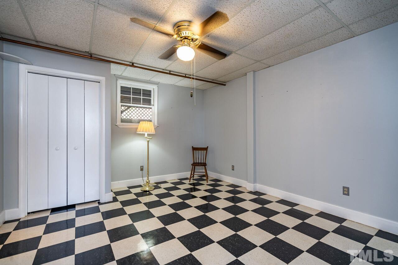 5212 Theys Road Raleigh, NC 27606 - Photo 40 of 55 a bedroom with a black and white checkered floor