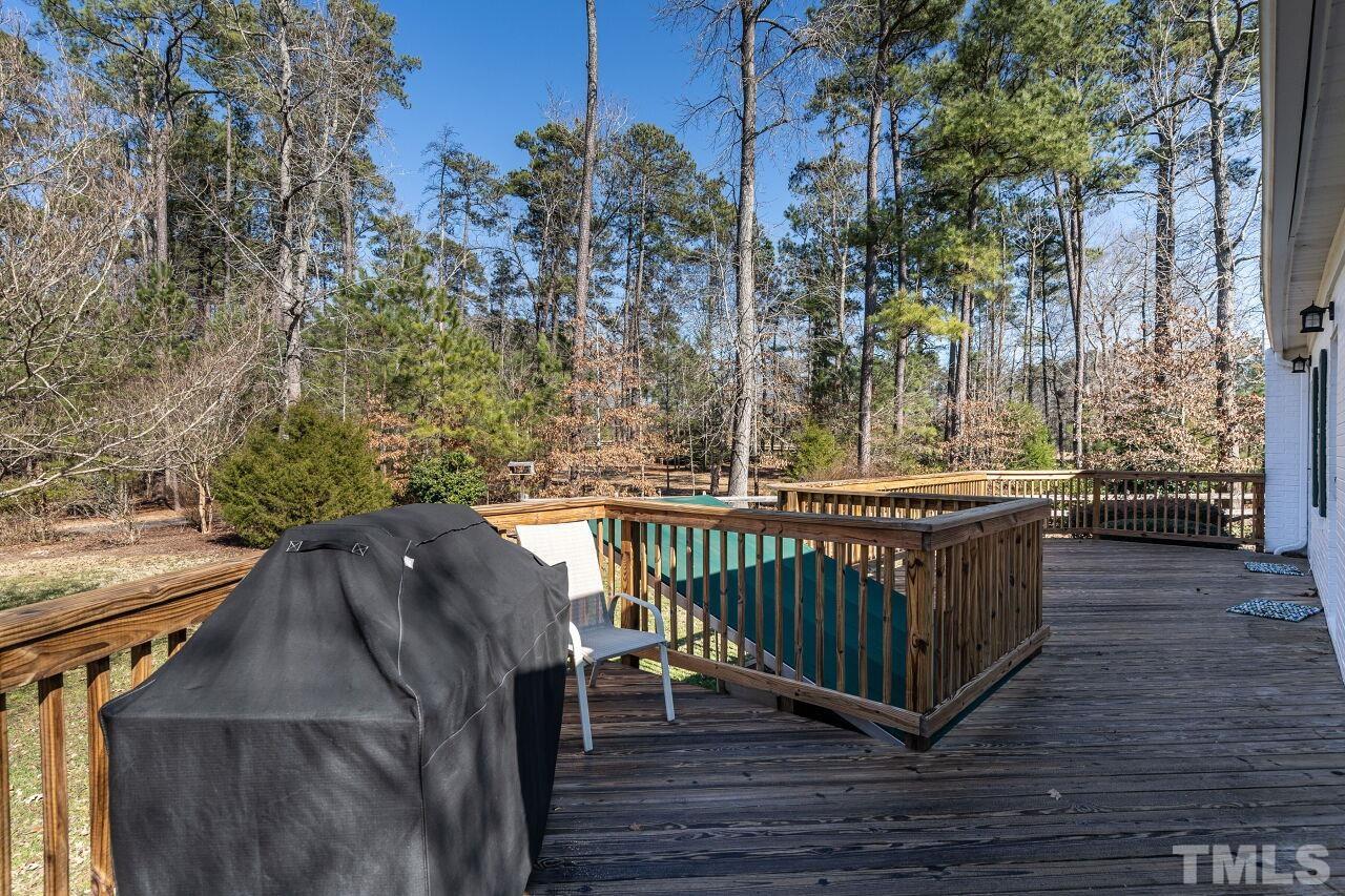 5212 Theys Road Raleigh, NC 27606 - Photo 41 of 55 a view of balcony with wooden floor and outdoor seating
