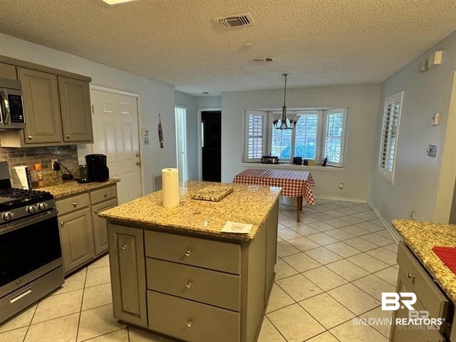 23393 Miflin Road Foley, AL 36535 - Photo 5 of 12 Kitchen featuring visible vents, gray cabinetry, a center island, stainless steel appliances, and light tile patterned floors