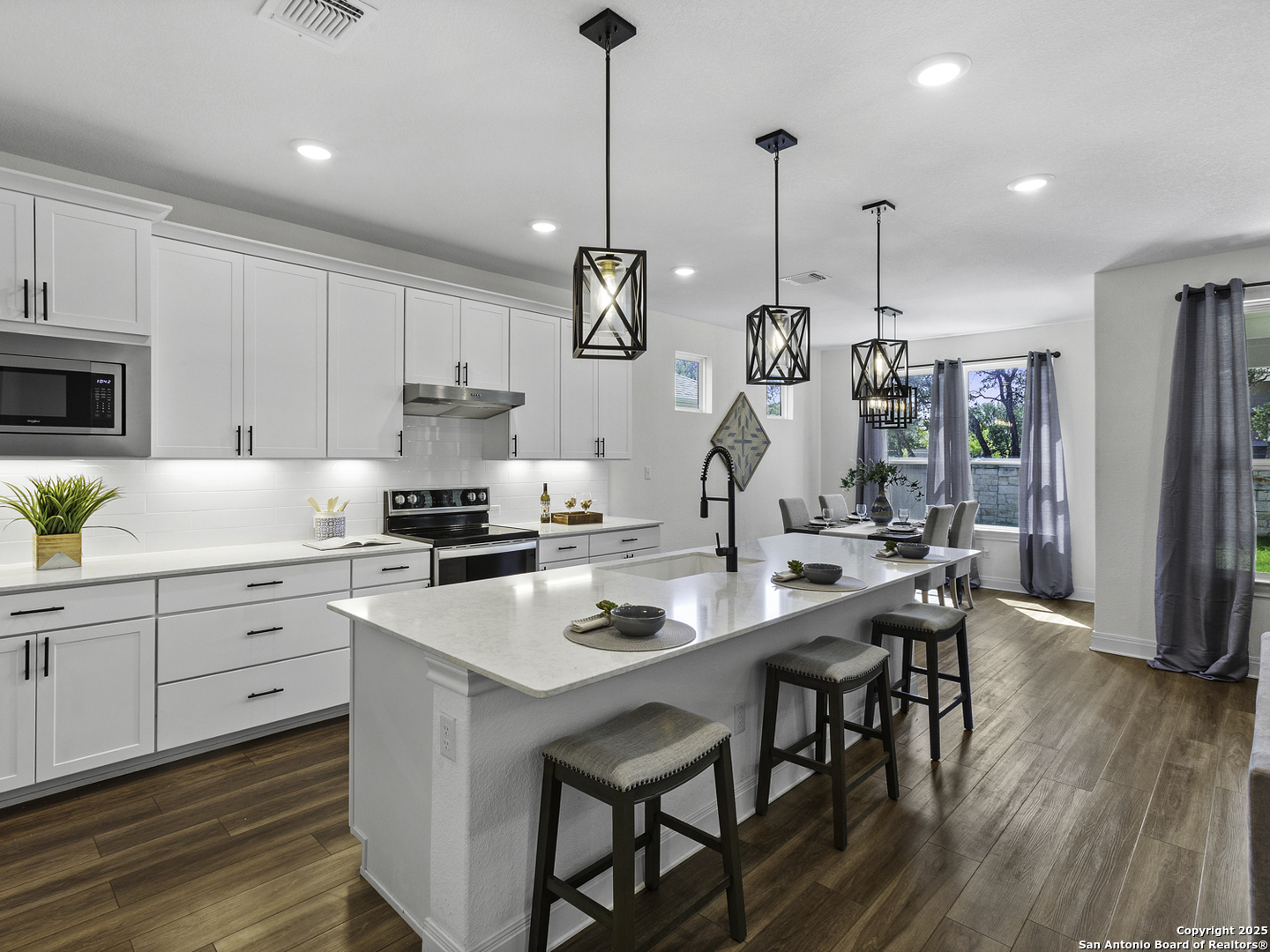 125 Slenderleaf Marble Falls, TX 78654 - Photo 3 of 49 a kitchen with stainless steel appliances kitchen island granite countertop a table chairs in it and white cabinets