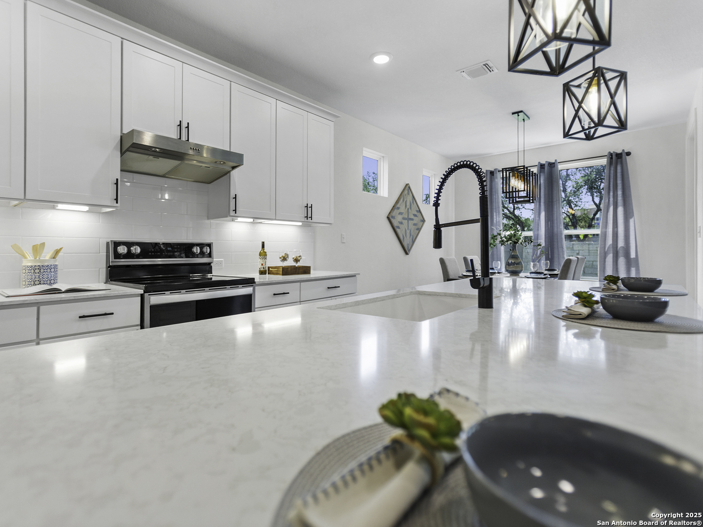 125 Slenderleaf Marble Falls, TX 78654 - Photo 46 of 49 a kitchen with stainless steel appliances granite countertop a sink a stove and a wooden floors