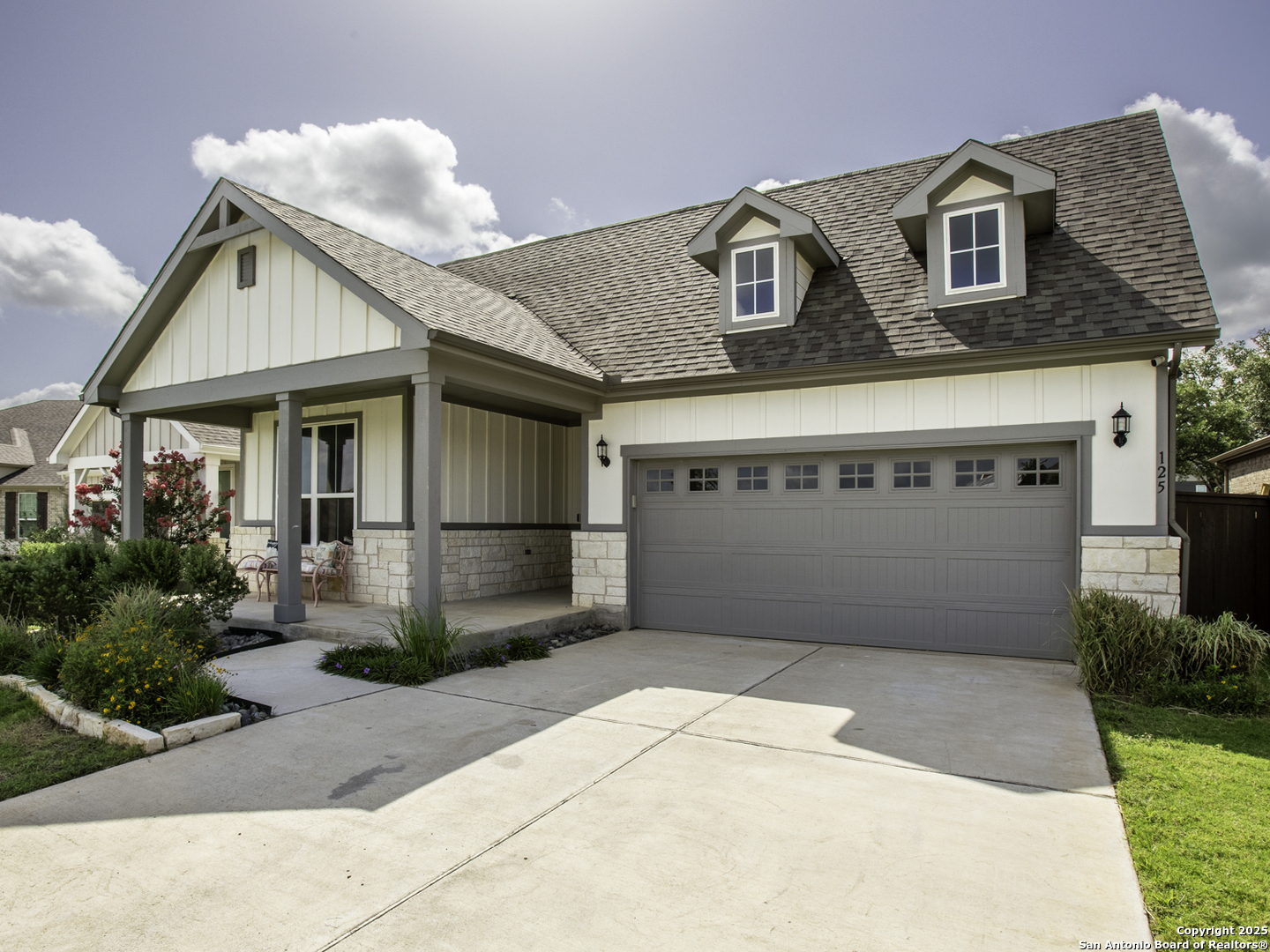 125 Slenderleaf Marble Falls, TX 78654 - Photo 47 of 49 a front view of a house with a garage and a yard