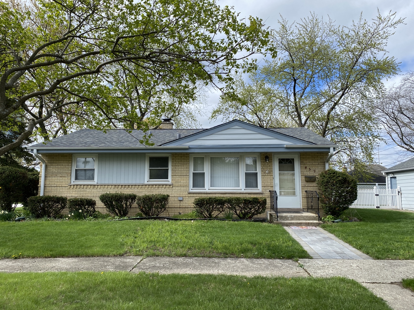 a front view of a house with a garden