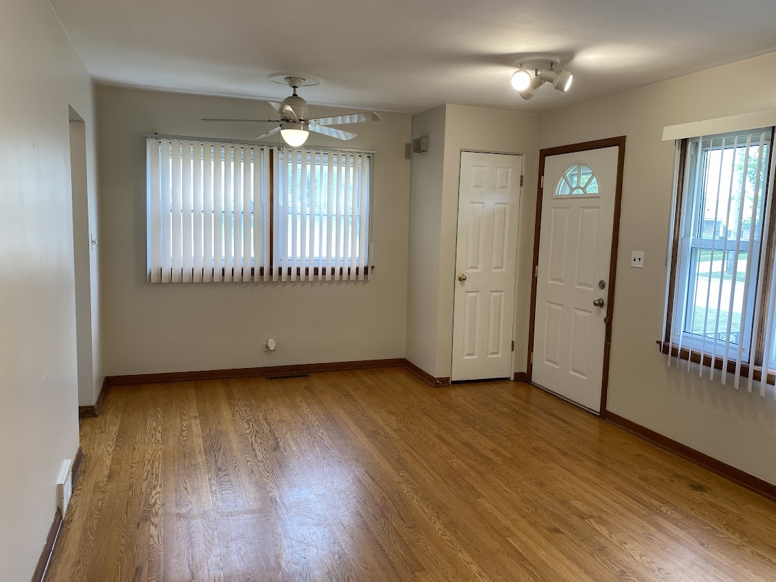 459 West Butterfield Road Elmhurst, IL 60126 - Photo 2 of 17 an empty room with wooden floor and windows