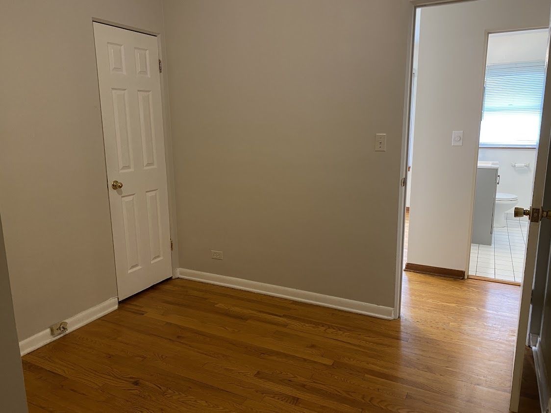 459 West Butterfield Road Elmhurst, IL 60126 - Photo 8 of 17 an empty room with wooden floor and windows