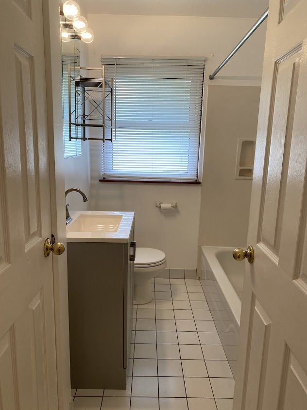 459 West Butterfield Road Elmhurst, IL 60126 - Photo 9 of 17 a bathroom with a sink a toilet and shower