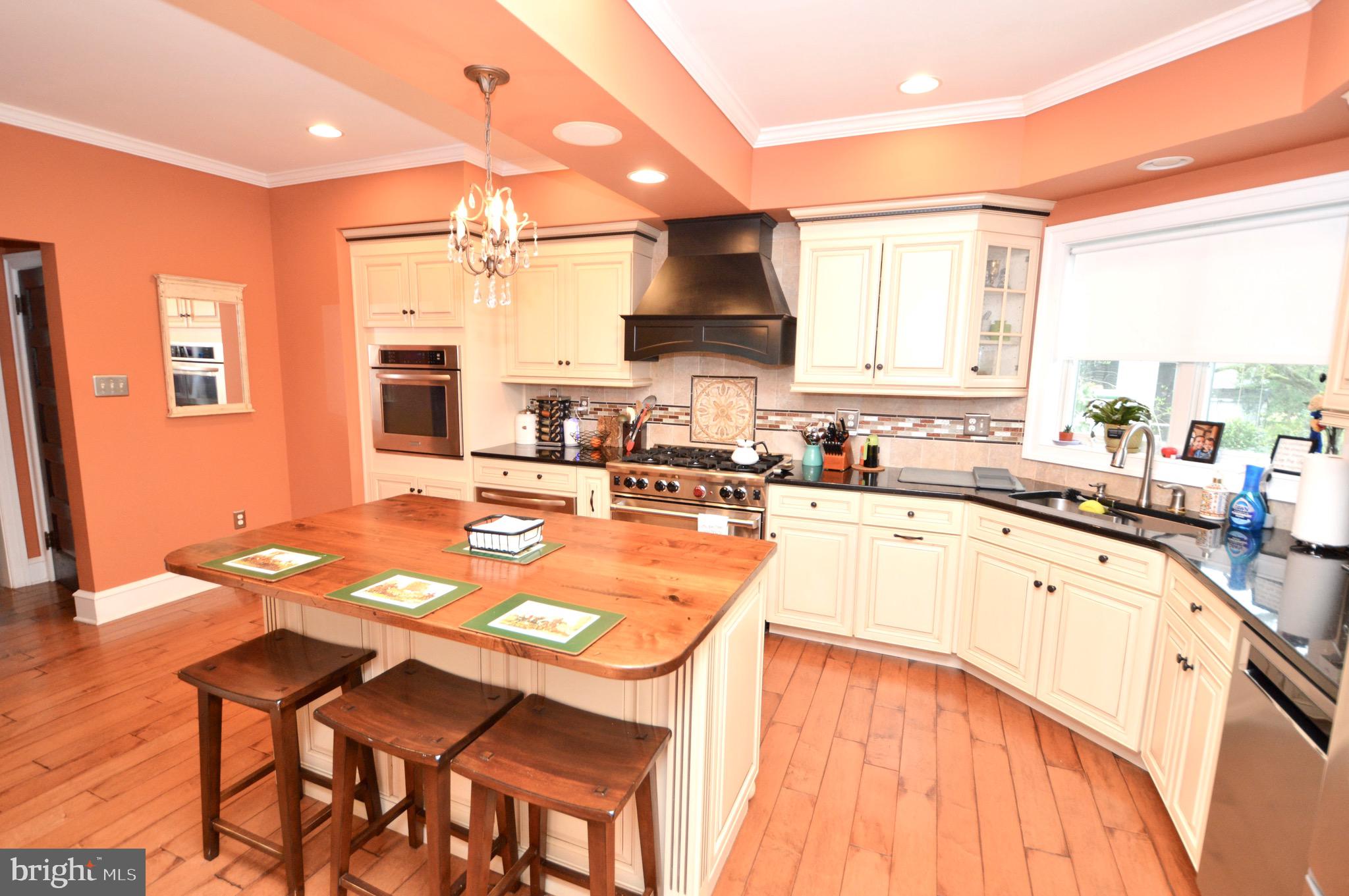 18 10th Avenue Haddon Heights, NJ 08035 - Photo 7 of 22 a kitchen with stainless steel appliances granite countertop a sink a stove a refrigerator cabinets and dining table