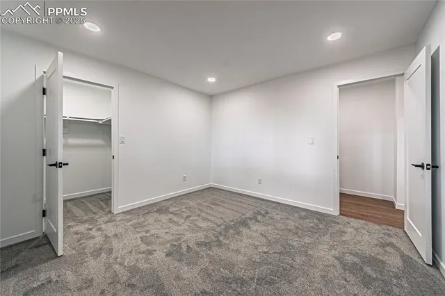 an empty room with closet and wooden door