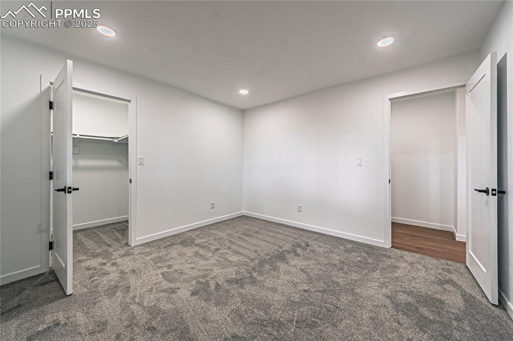 12480 Partridge Lane Peyton, CO 80831 - Photo 19 of 38 an empty room with closet and wooden door