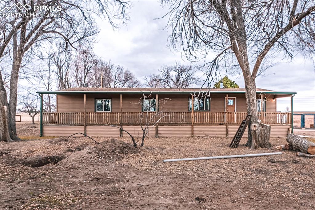 12480 Partridge Lane Peyton, CO 80831 - Photo 2 of 38 a view of a house with a yard covered in snow