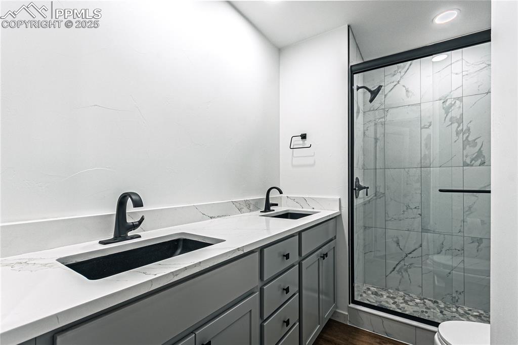 12480 Partridge Lane Peyton, CO 80831 - Photo 25 of 38 a bathroom with a sink and mirror