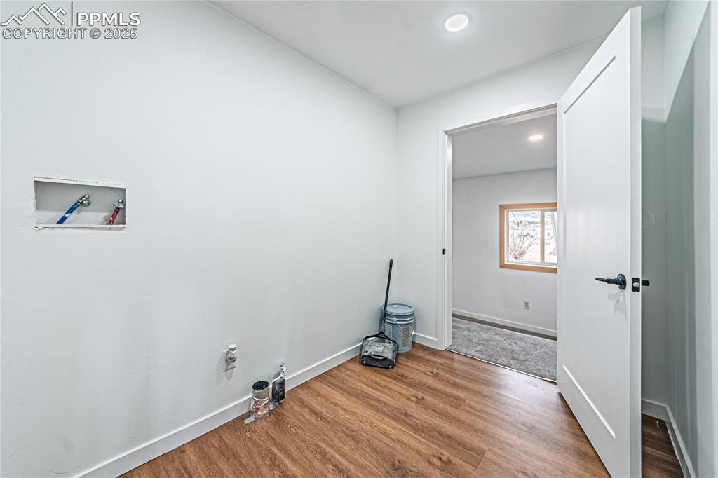 12480 Partridge Lane Peyton, CO 80831 - Photo 26 of 38 a view of a room with wooden floor and a bathroom